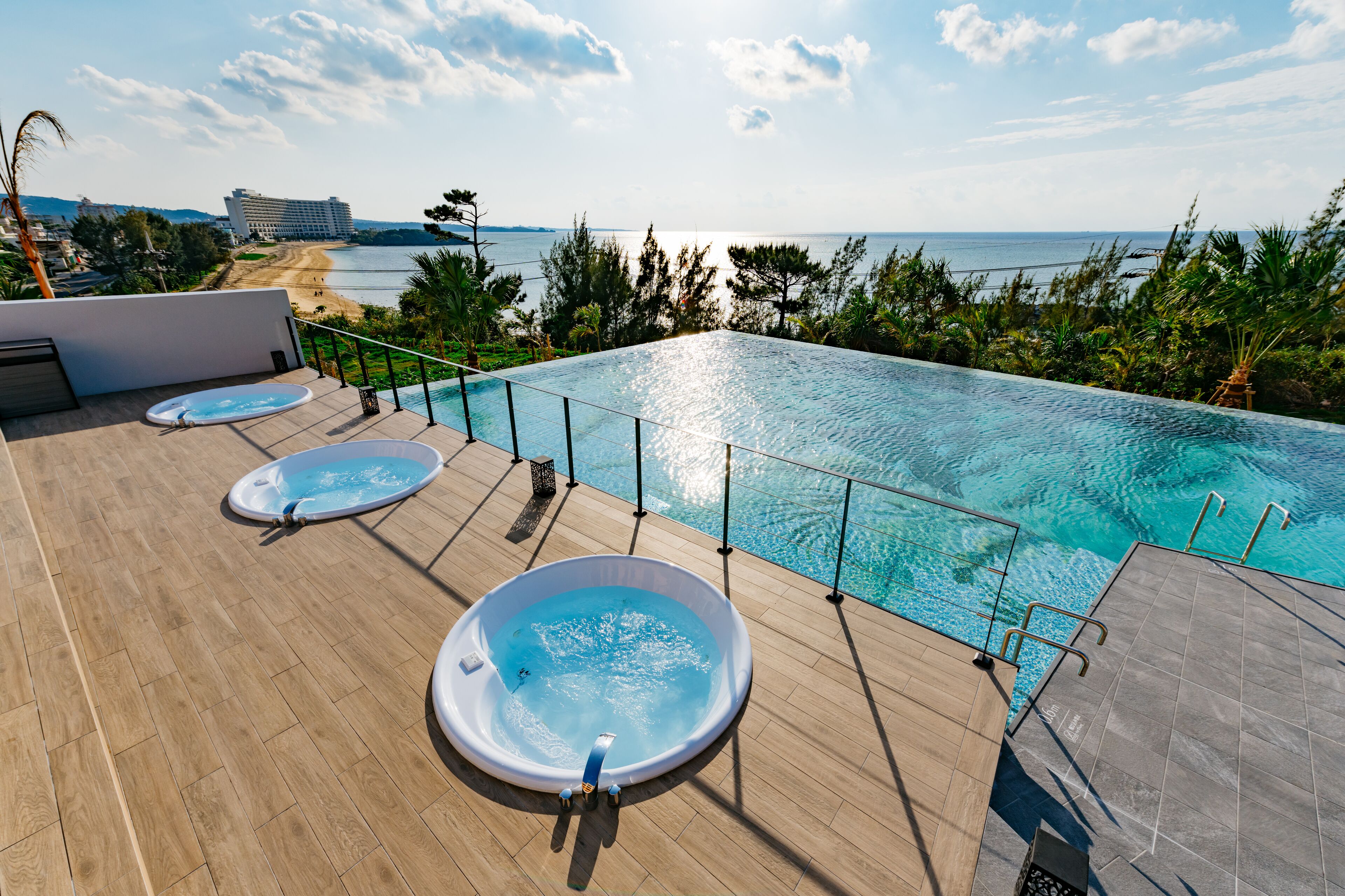 A rooftop infinity pool with a view of the beach and ocean.