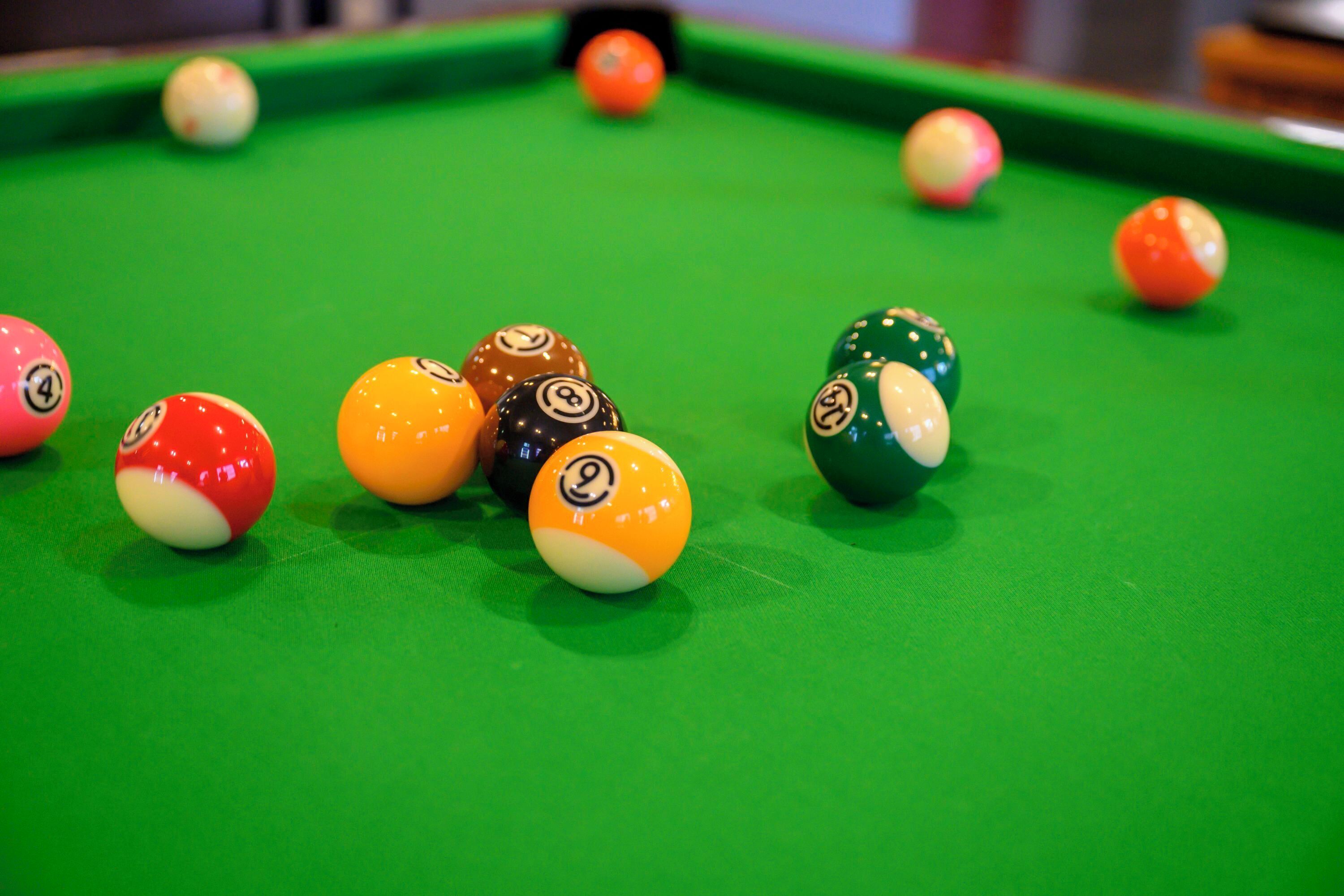 A pool table with various numbered balls.