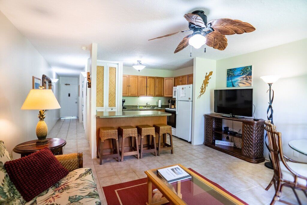 A compact living space with a kitchen, dining area, and a TV.