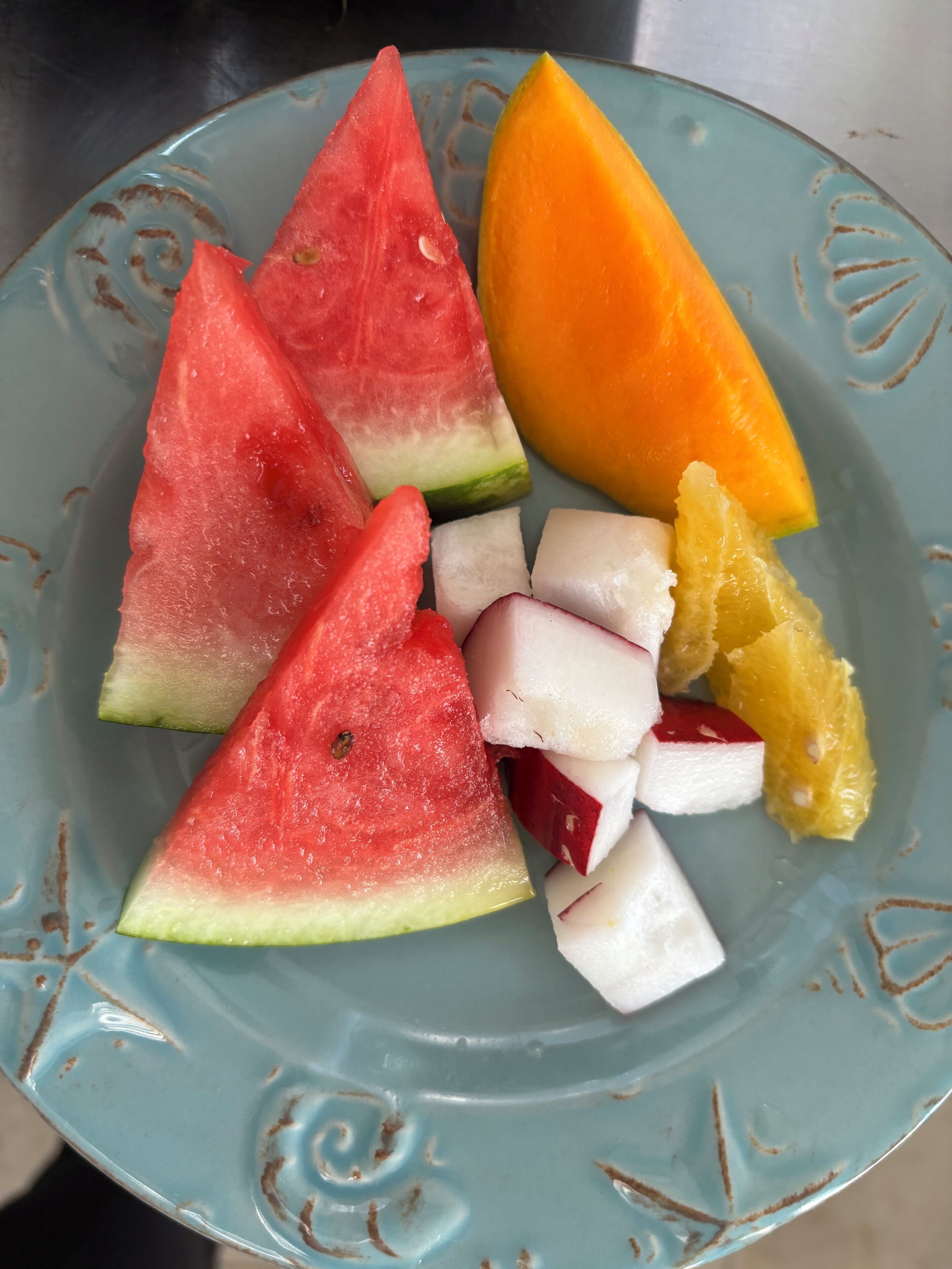 A plate with watermelon, mango, and pineapple chunks.