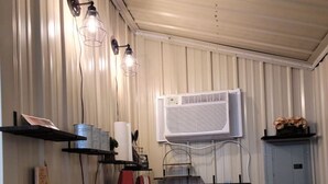 A compact kitchen with a built-in air conditioner, a red blender, and a granite countertop. - City limits, off interstate I20 & west co rd WIFI (Odessa)