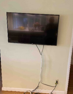 Enjoy entertainment at your fingertips with a flat-screen television mounted on the wall.