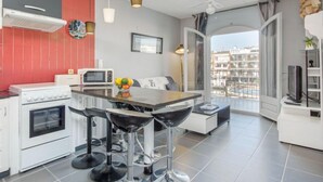 Une cuisine moderne dotée d’un îlot central, de tabourets de bar, d’un four à micro-ondes et d’une cuisinière.