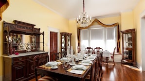 A formal dining room with a long wooden table set for a meal, surrounded by chairs. - Oaklea Mansion Bed and Breakfast (Winnsboro)