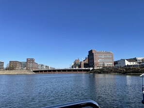 A waterfront view with buildings, including a prominent brick structure and a modern glass building. - Hausboot Lore (Duisburg)