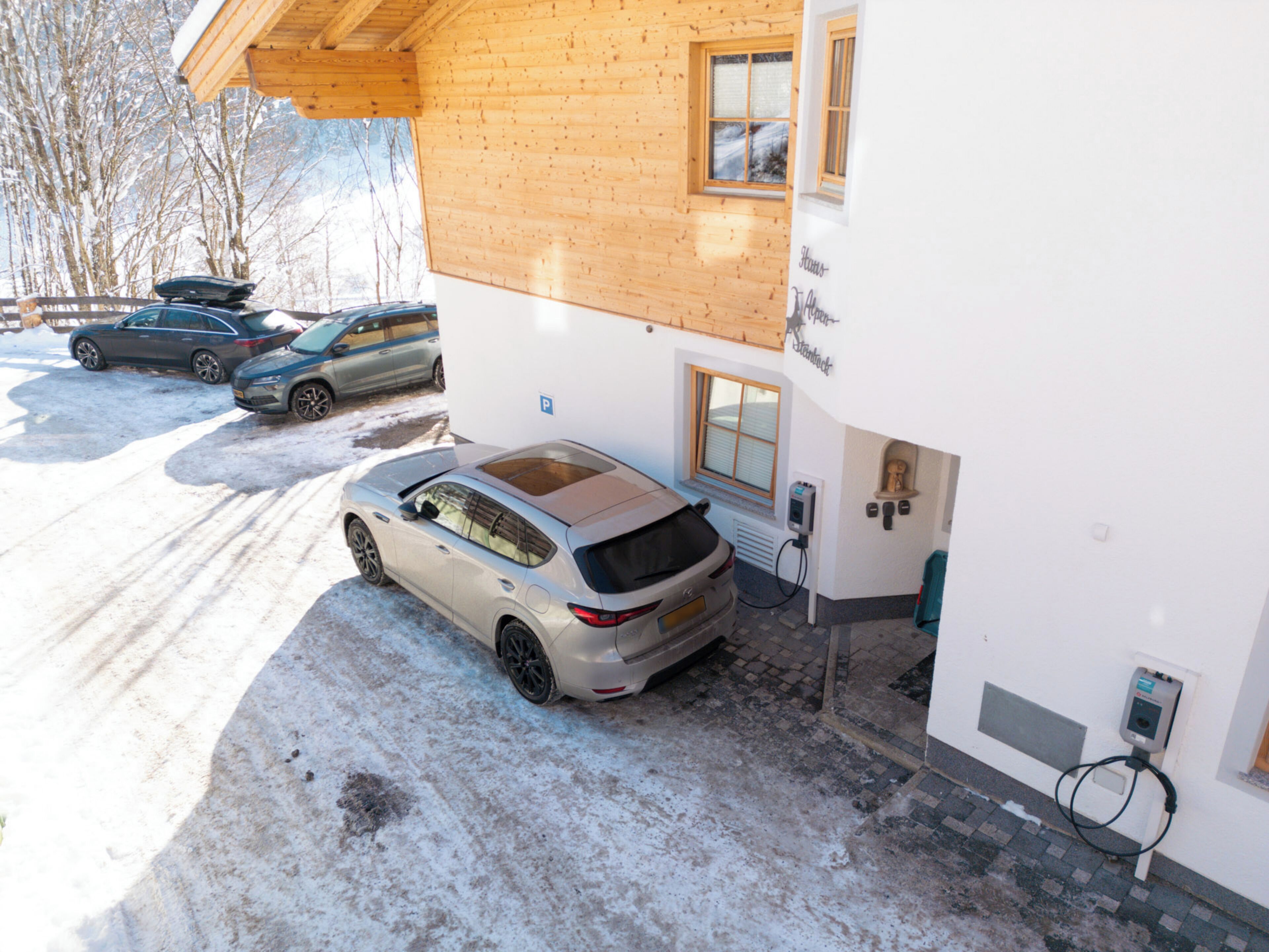 A building with a wooden exterior and a car parked in front.