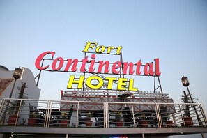 A sign for Fort Continental Hotel with a clear view of the hotel's name and a balcony with potted plants. - Fort Continental Hotel (Peshawar)