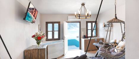 Un baño moderno con bañera, ducha y un ventanal con vistas al mar.