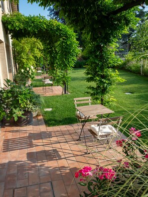 A patio area with outdoor seating and a well-maintained lawn.