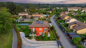 A residential area with houses, a swimming pool, and solar panels.