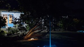 A nighttime outdoor scene with a glowing blue orb and a vertical light pole. - Moana Breeze Eco Lodge (Rangiroa)