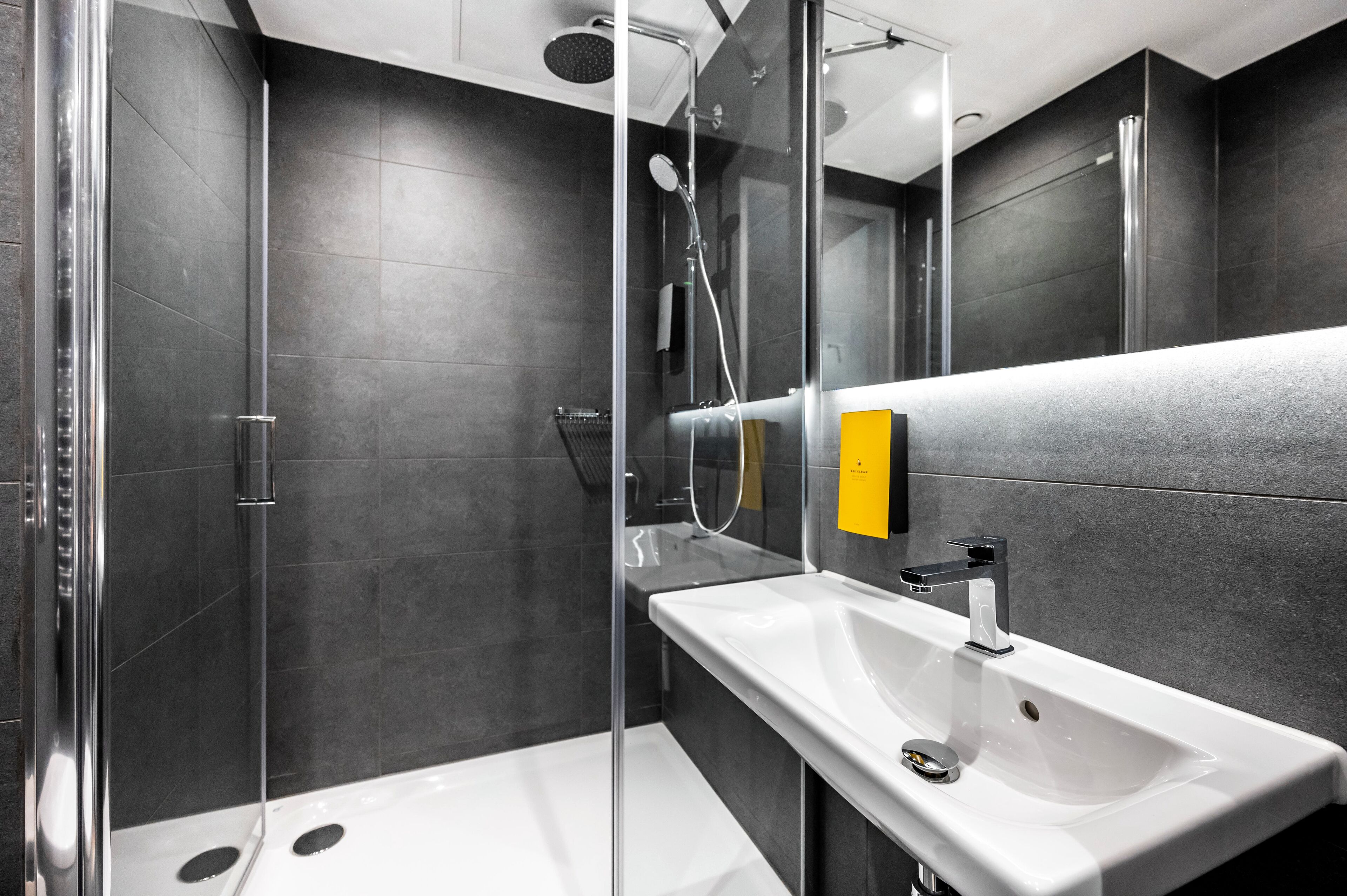 studio. | bathroom | shower, rainfall showerhead, hair dryer, towels