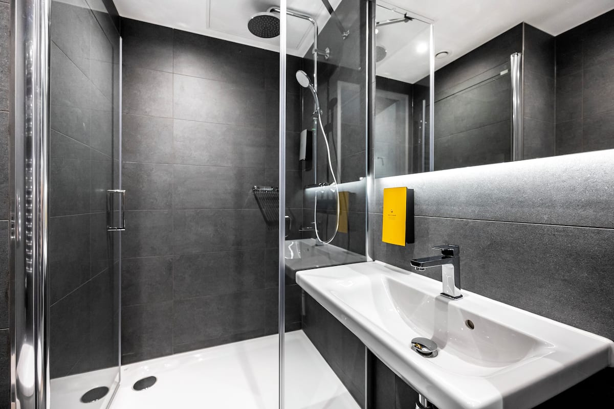 studio. | bathroom | shower, rainfall showerhead, hair dryer, towels
