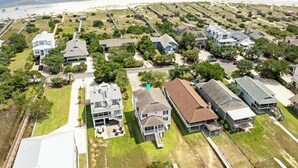 A coastal residential area with houses, a beach, and a boardwalk. - Creek Front Beach House, 3 Screened Porches, Private Dock, Easy Walk to Beach (Pawleys Island)