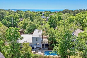 A residential area with houses, a swimming pool, and a clear view of the ocean. - Private Pool Beach House, Easy Walk to Beach, 2 Screened Porches, Dog Friendly (Pawleys Island)