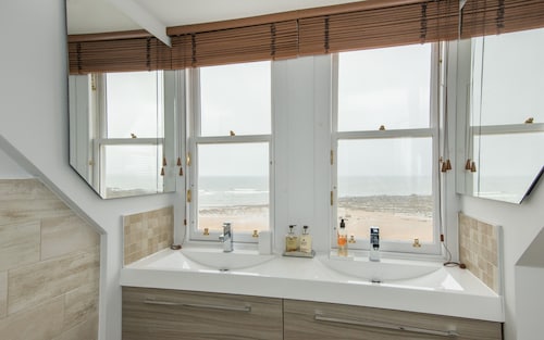 A 4-bedroom luxury holiday home with enchanting sea views across Milsey Bay Beach