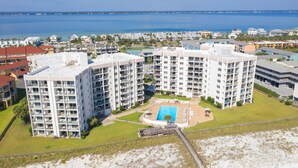A high-rise hotel with multiple balconies, a swimming pool, and a view of the ocean. - 1 Bedroom, 1 Bath Gulf Front Condo t Regency Towers 603 East! (Pensacola Beach)
