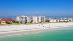 A beachfront hotel with multiple buildings, a sandy beach, and clear turquoise waters. - 1 Bedroom, 1 Bath Gulf Front Condo t Regency Towers 603 East! (Pensacola Beach)