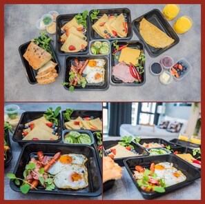 A meal prep with various dishes including eggs, meats, and vegetables in black containers.