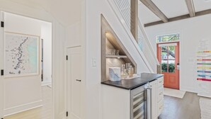 A modern kitchen with a built-in oven, a countertop, and a wooden ceiling. - Bikes | Pool | Ping Pong | Beach Service (Santa Rosa Beach)