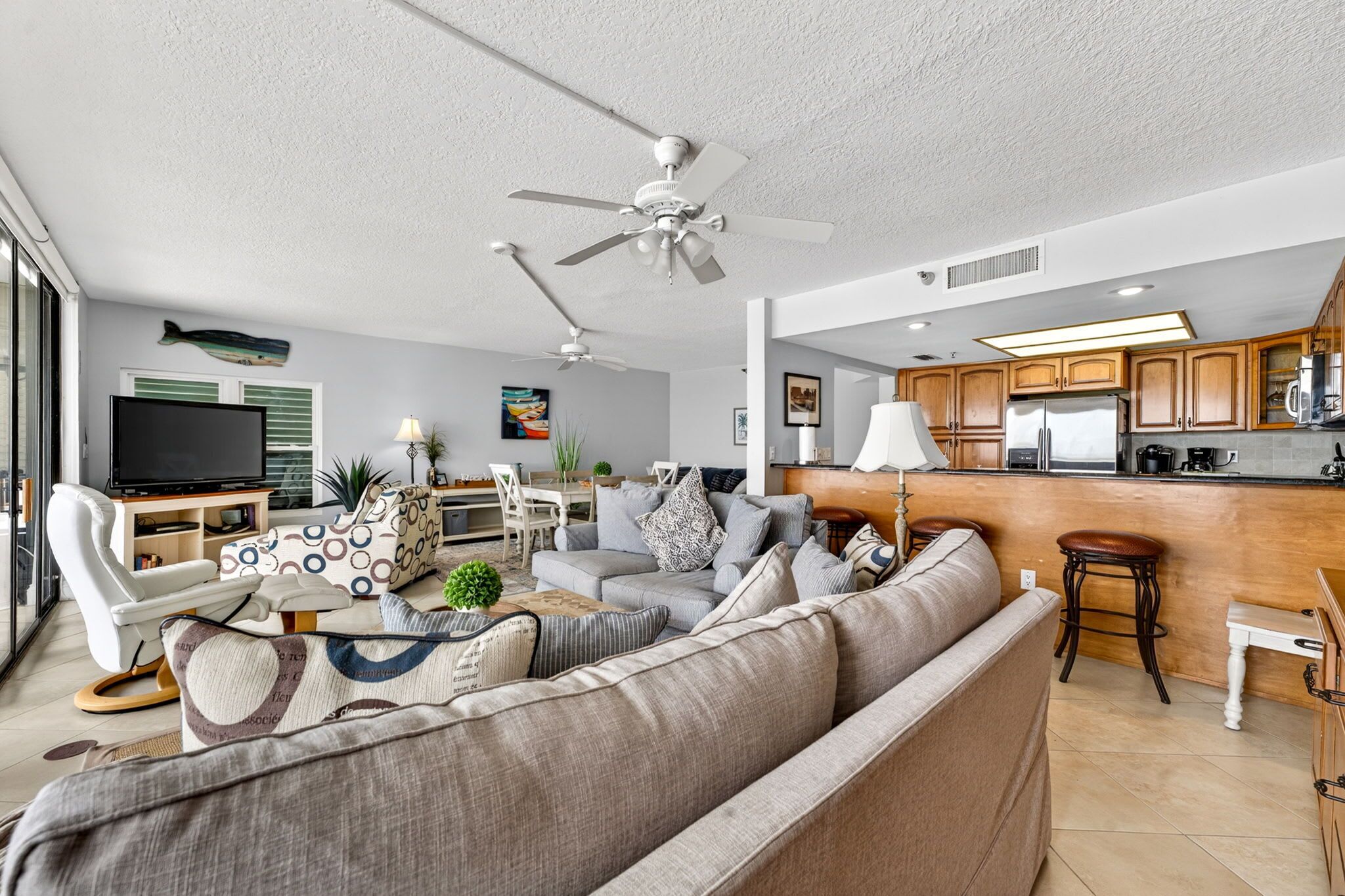 A modern living room with a sofa, TV, and dining area.