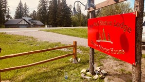 A red sign for The Red Station Lodge, a Station Master House.
