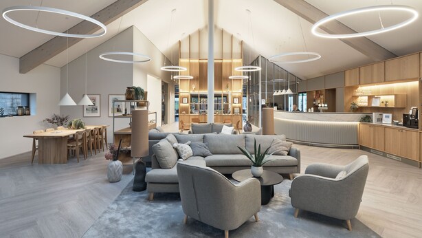 A spacious living area with a high ceiling, modern furniture, and a skylight.