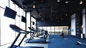 A gym with treadmills, exercise bikes, and weights. - Luxurious 3 Bedrooms with Maid room Villa (دبي)