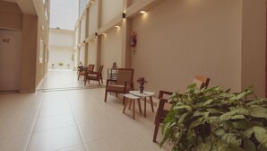 A spacious indoor area with high ceilings, tiled floors, and multiple seating arrangements. - Hotel Tonight (Salta)