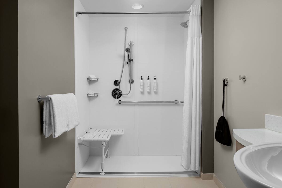 designer toiletries, hair dryer, towels, soap