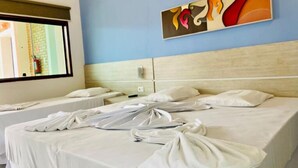 A hotel room with two beds, a large window, and a wall-mounted abstract painting. - Pousada Porto do Rio Praia (Caraguatatuba)