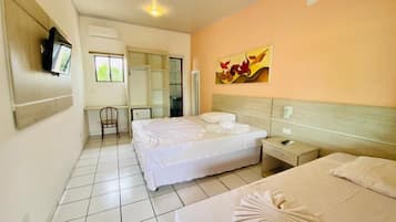 A hotel room with two beds, a television mounted on the wall, a chair, and a painting on the wall.