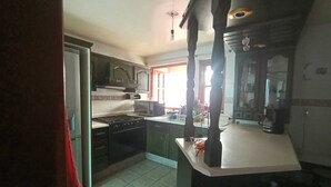 A kitchen with a stove, microwave, and cabinets. - Beautiful house in private, a few minutes from downtown!!!! (Oaxaca de Juárez)