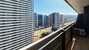 A high-rise building with a modern design, featuring a series of horizontal lines and a large windowed facade. - Orbi City/Two Rooms Apt./27 Floor/Sea - Mout. View (Batumi)