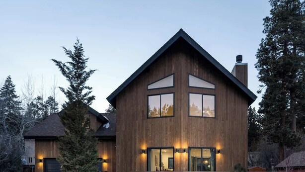 A modern two-story house with a wooden exterior, large windows, and a visible garage. - Yuhaaviat House | Walk to restaurants - Dogs OK (Big Bear Lake)