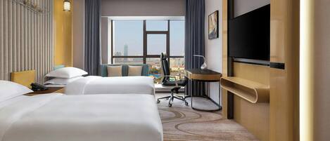 A hotel room with two beds, a desk, a chair, a TV, and a large window offering a city view.