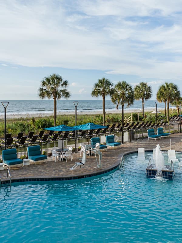 Outdoor pool, open 7:00 AM to 11:00 PM, pool umbrellas, sun loungers