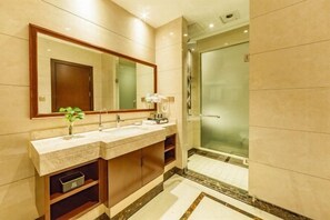 A modern bathroom with a double sink vanity, a large mirror, and a glass-enclosed shower. - Jing Cheng Hotel (Jiashan)