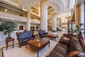 A spacious lobby with a grand staircase, ornate sofas, and a large chandelier. - Jing Cheng Hotel (Jiashan)