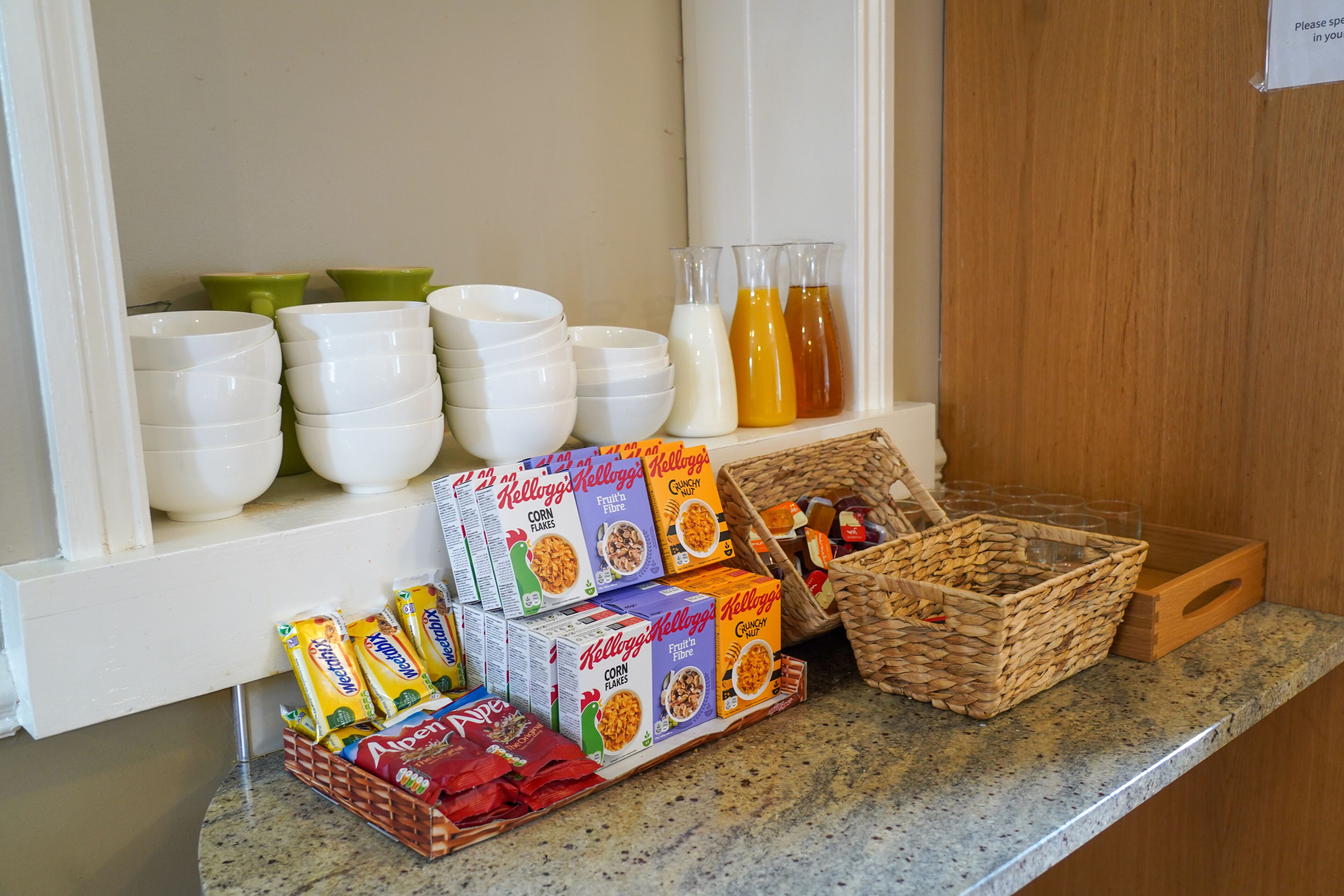 A kitchen counter with various food items and containers.