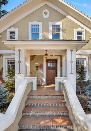 A two-story house with a front porch, a wooden door, and a number "1325" on the wall. - Stunning Historic Home on Bend's West Side (Bend)