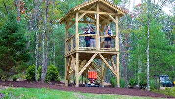 Enjoy panoramic views from the observation tower's balcony, offering a vantage point over the surrounding forest.