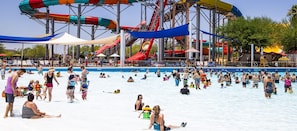 A water park with multiple water slides and a swimming pool area.