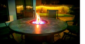Enjoy al fresco dining at this outdoor patio with a fire feature and comfortable seating.