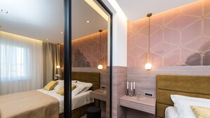 A modern hotel room with two beds, a desk, and a glass partition. - Two Bedroom Apartment with Terrace (Zadar)