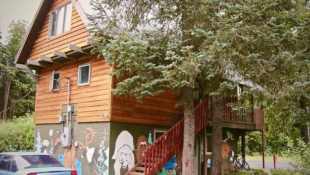 A wooden house with a staircase leading to a balcony. - Walk Almost Anywhere at Alyeska Resort when you stay at Chair Four Por Favor! (Girdwood)