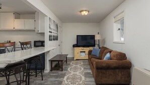 A compact living space with a kitchen, dining area, and seating area. - Walk Almost Anywhere at Alyeska Resort when you stay at Chair Four Por Favor! (Girdwood)