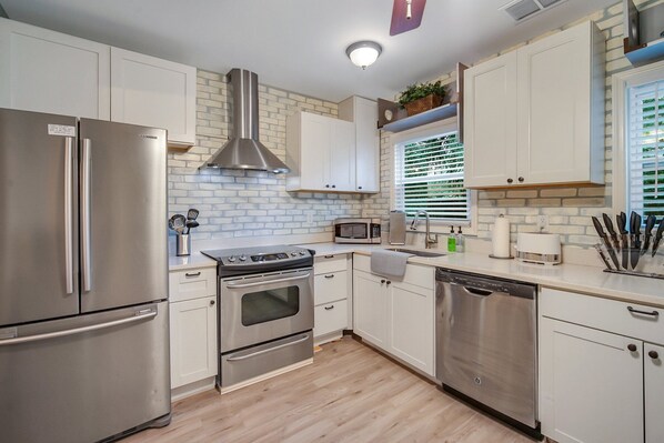 Enjoy cooking in this well-equipped kitchen with a refrigerator, oven, and dishwasher.