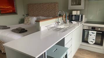 1 bedroom, desk, iron/ironing board, travel crib