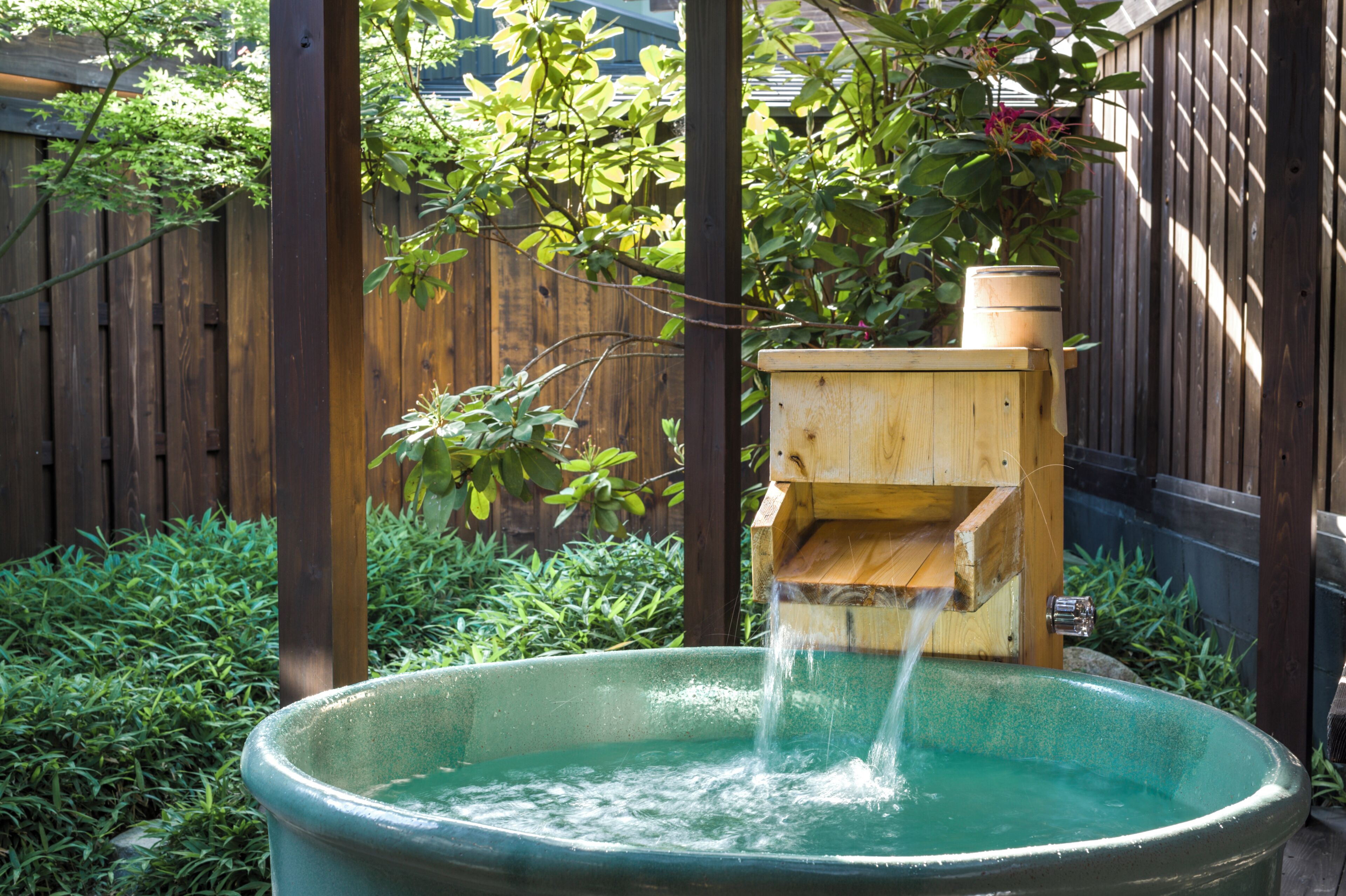 A wooden water feature with a wooden box and a large basin.